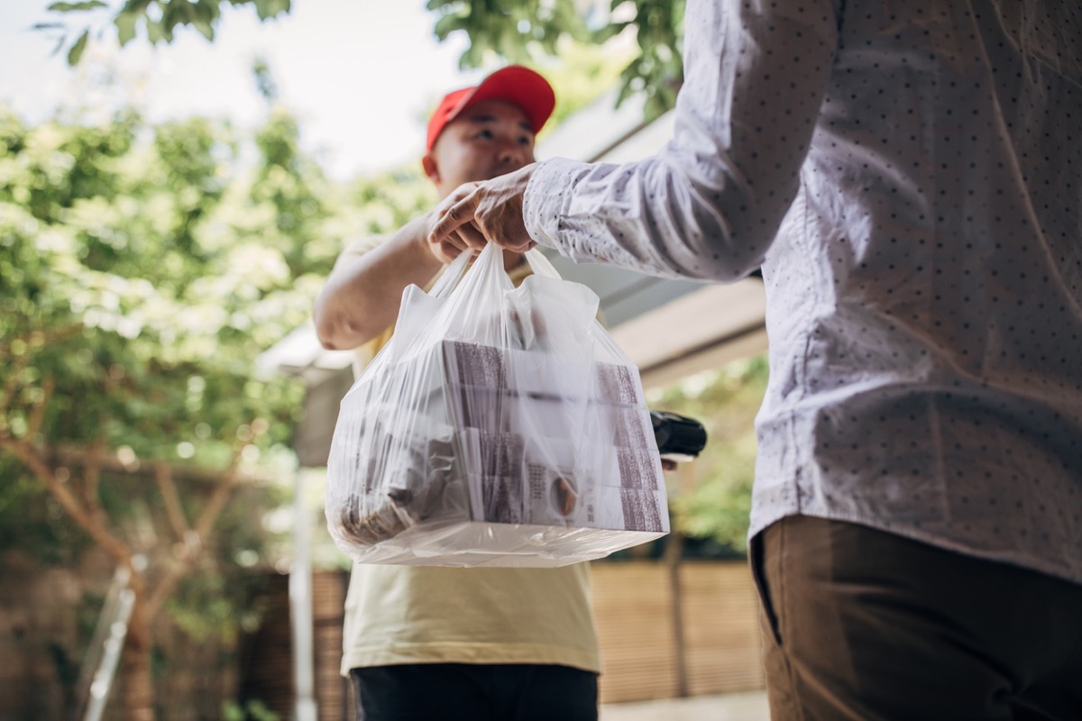 Delivery man bringing food to a customer