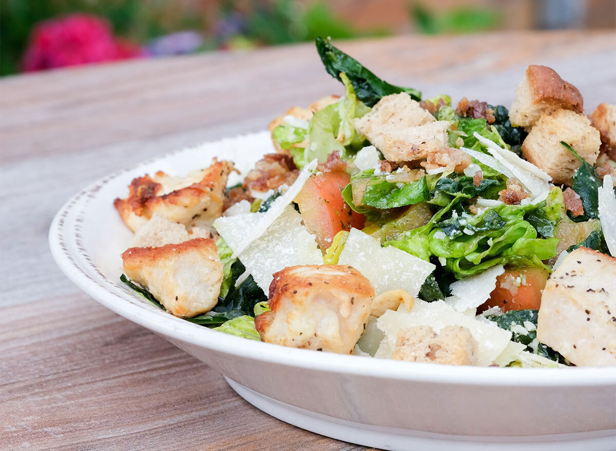 plated kale caesar salad with chicken