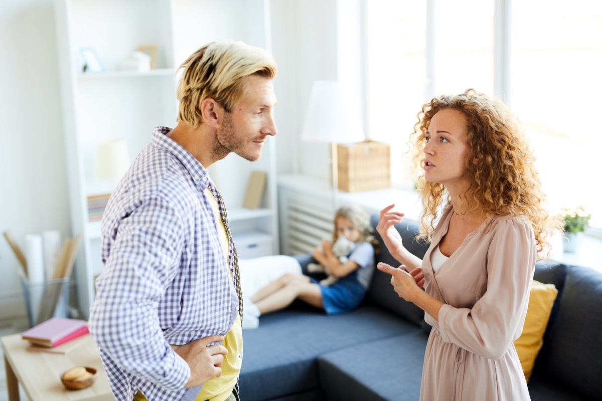 parents fighting while child looks on