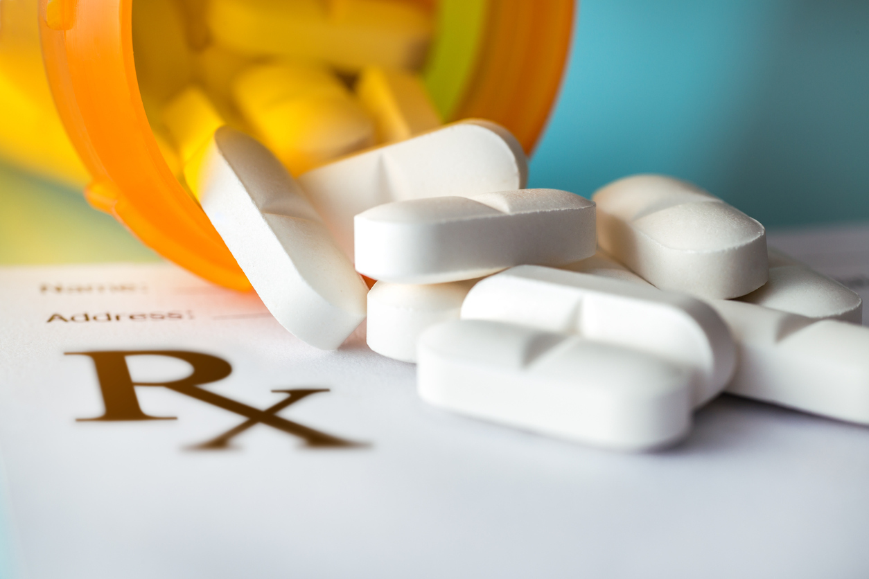 Pills coming out of a prescription bottle. 