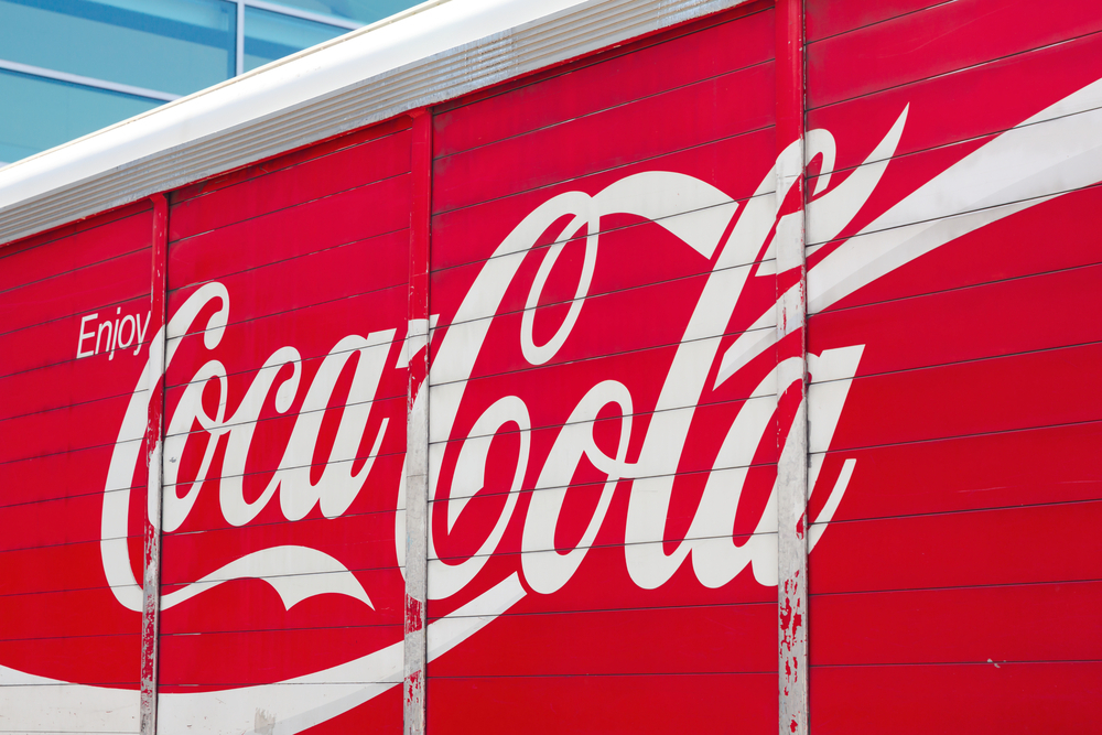 A Coca-Cola logo on the side of a delivery truck