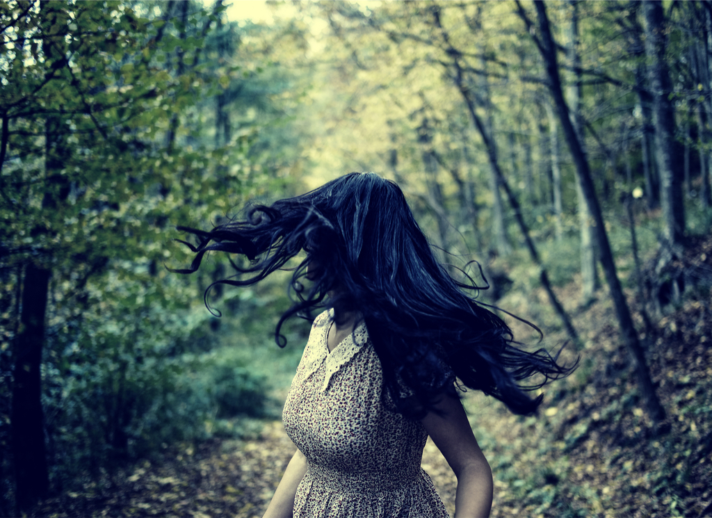 Woman being chased through woods