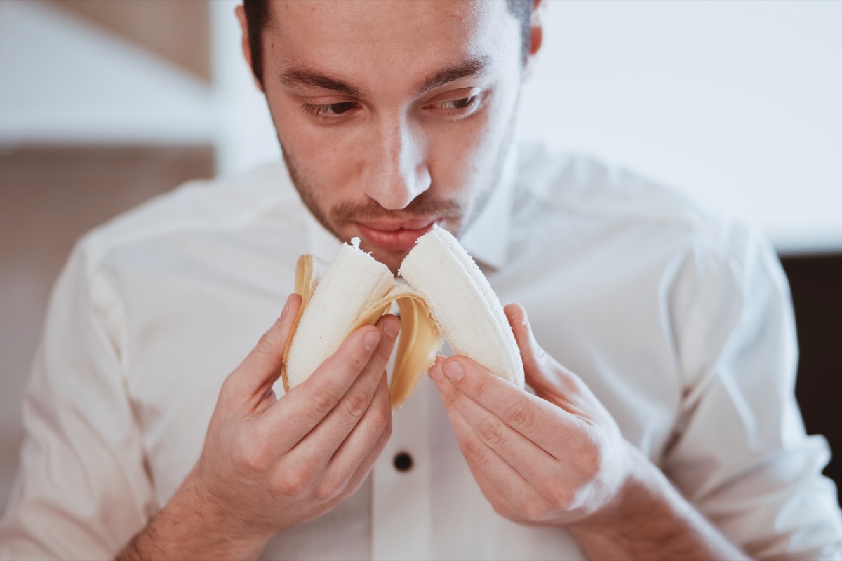 Man smelling banana