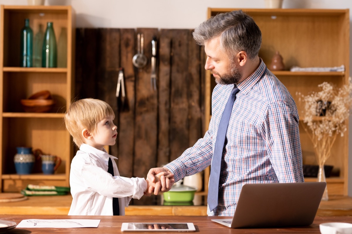 Father and son making a deal shaking hands