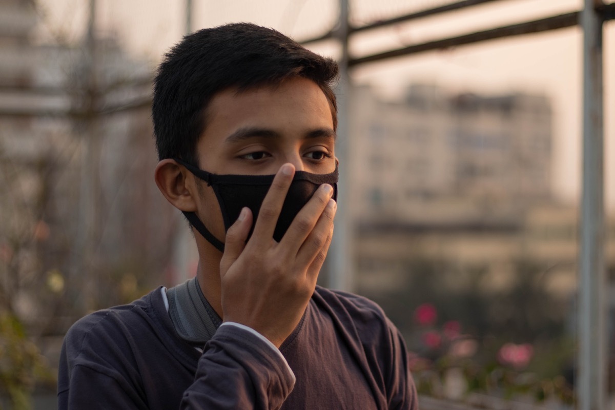 Young boy adjusting mask