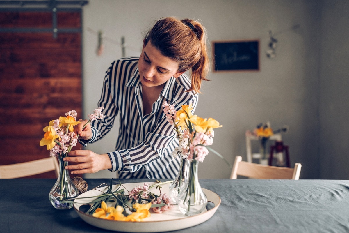 Young woman preparing dinner table