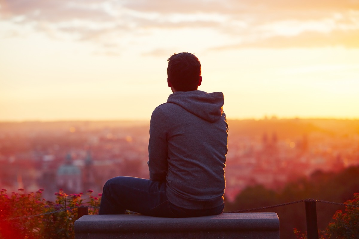 Man looks across the city. 