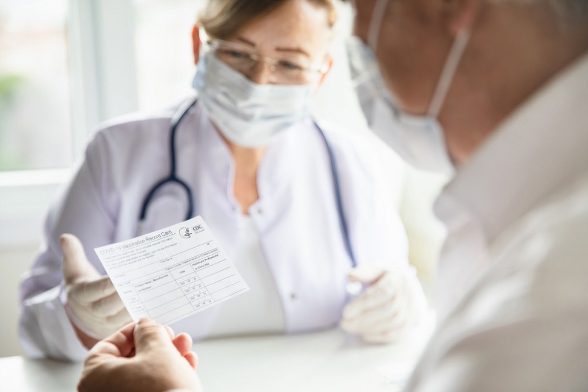 Man holding a vaccine card