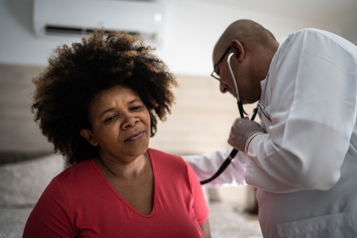 Doctor listening to patient's heartbeat