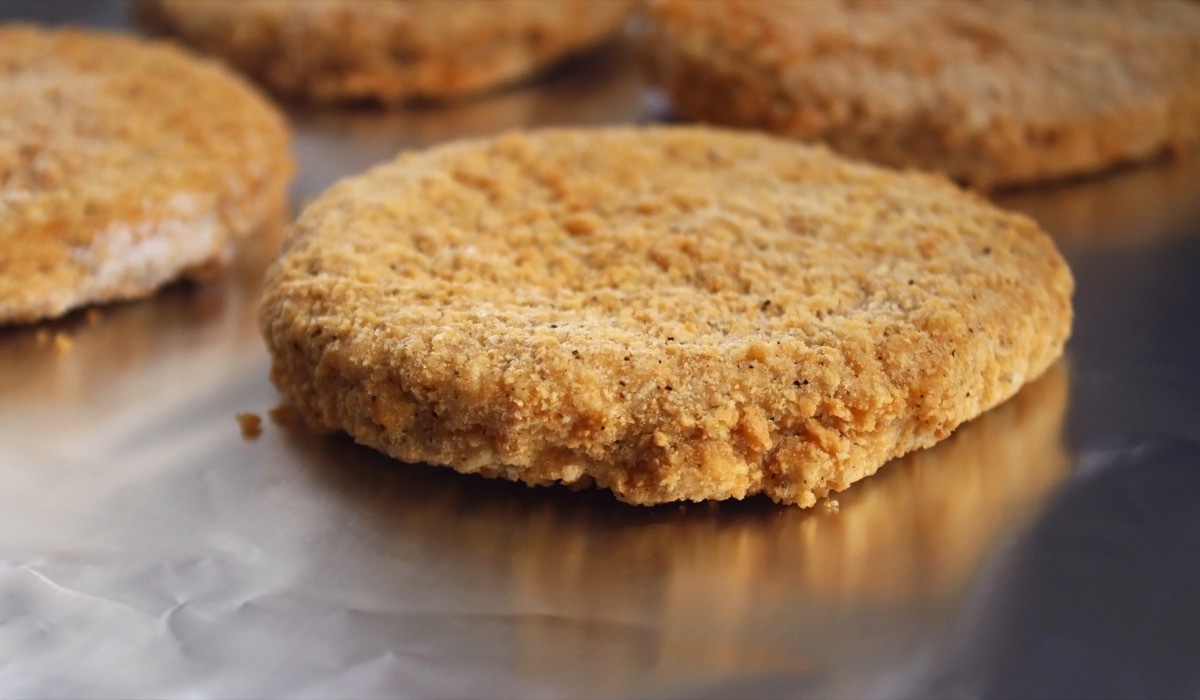 Frozen breaded chicken burger patty of foil - ready for cooking