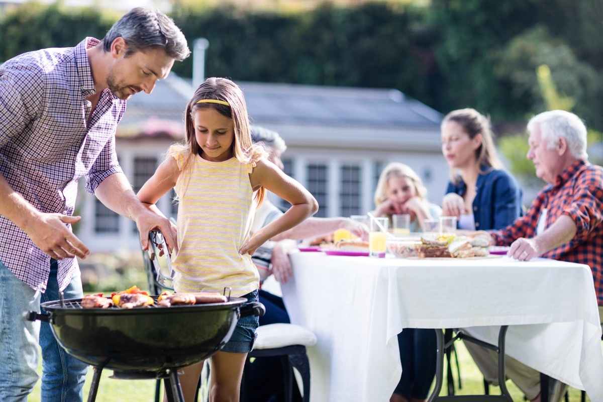 Dad barbecuing with daughter