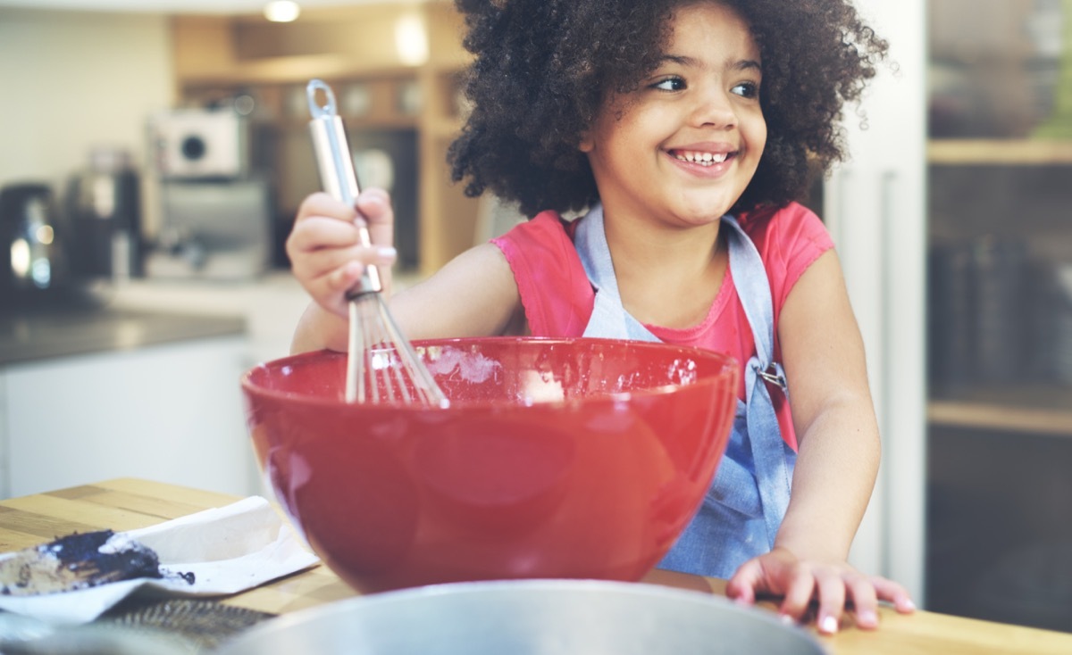 Little Girl Mixing in a Bowl Cooking Childhood Habits that Affect Adult Health