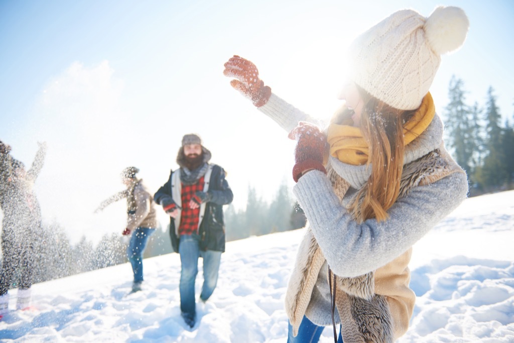 Adults having a snowball fight