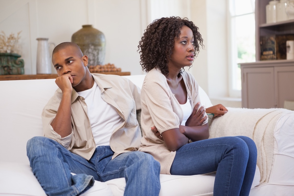 Couple ignoring each other on the couch during a fight