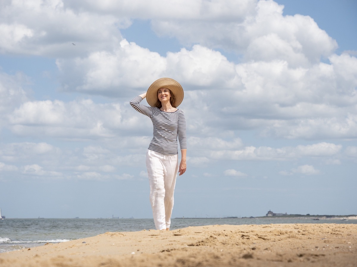 carefree mature woman wearing linen pants