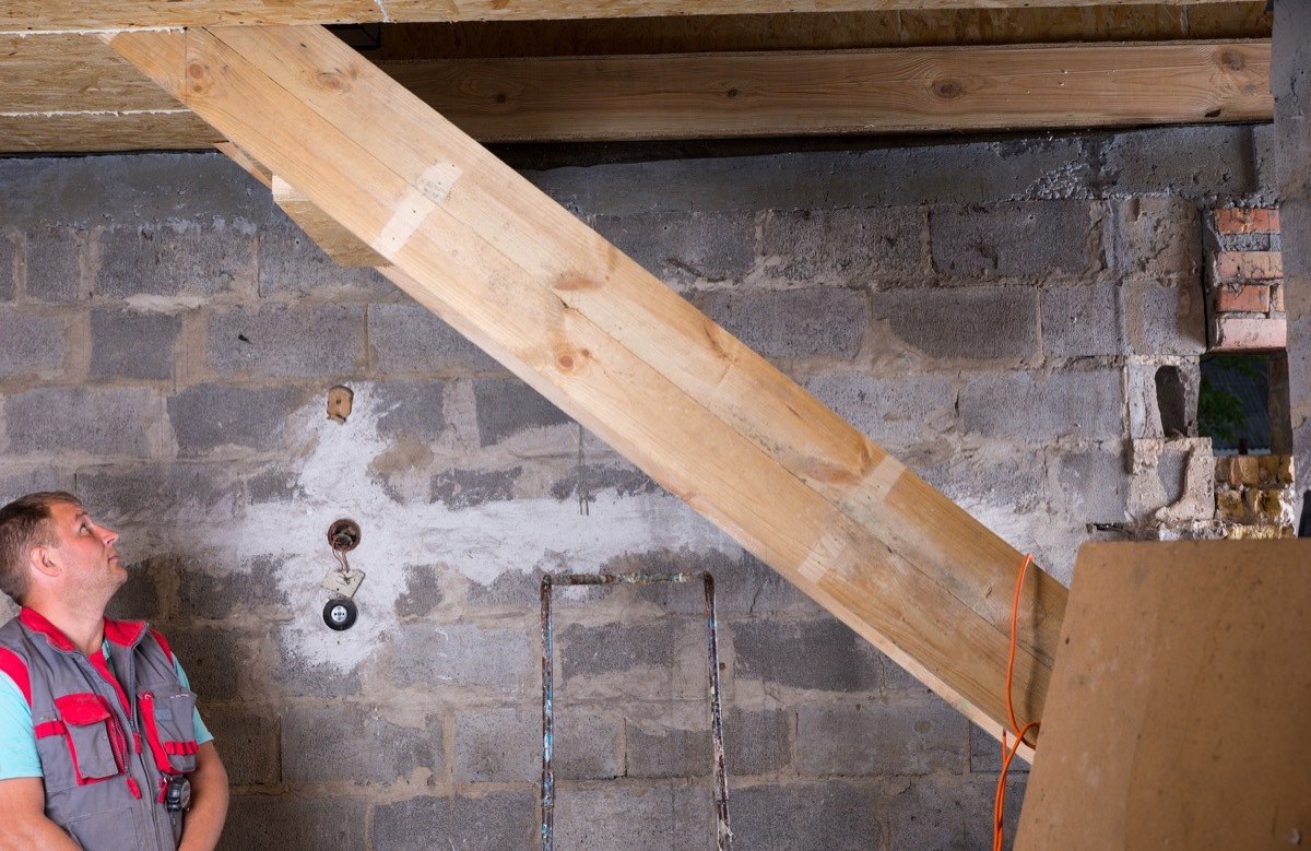 white man standing in unfinished basement