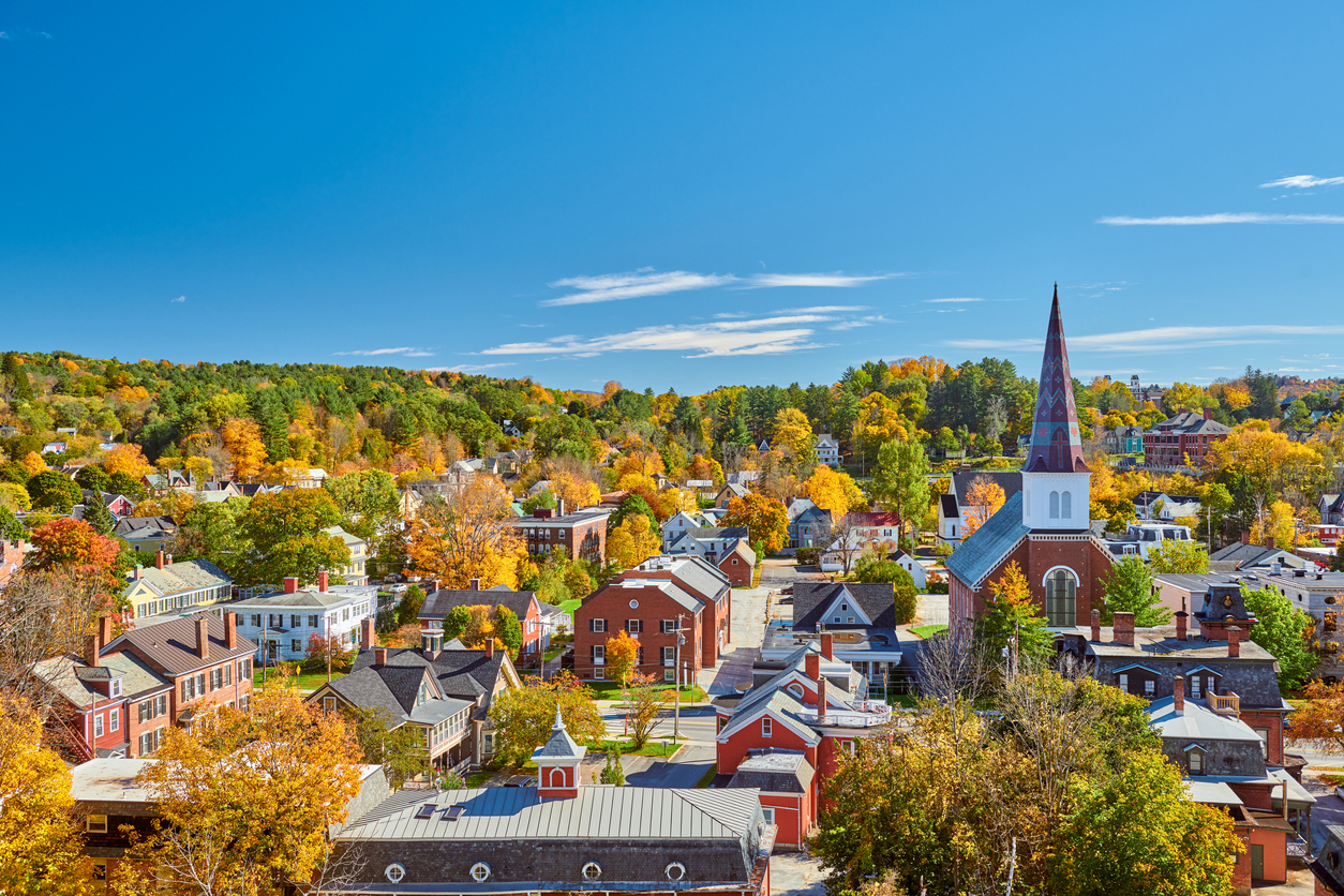 The skyline of Montpelier, Vermont in autumn with brick buildings and a church steeple