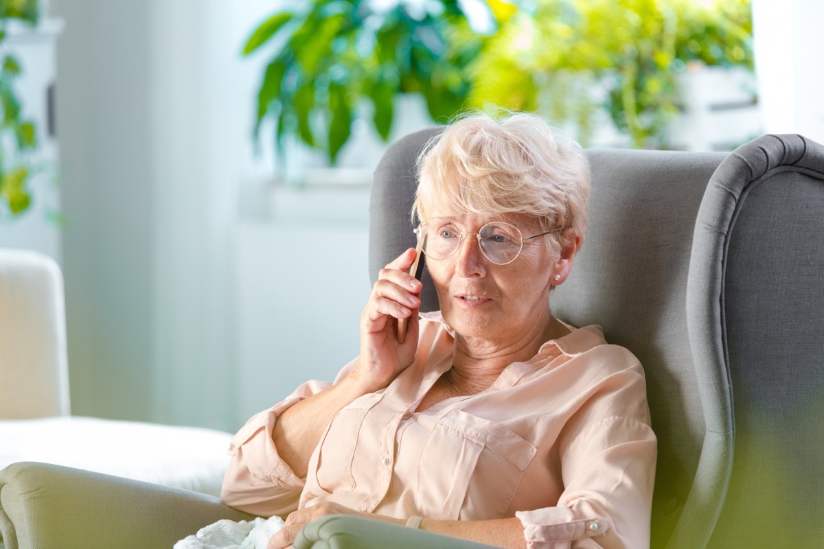 Shot of a senior woman talking on mobile phone while sitting in her room