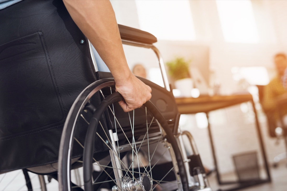 A disabled man is sitting in a wheelchair