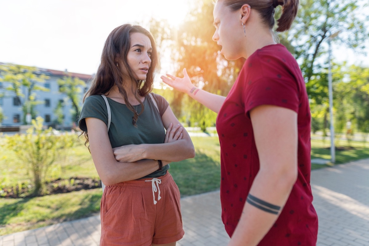 attractive young couple arguing while meeting in the city