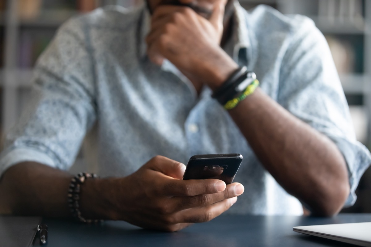 man looking at text on phone