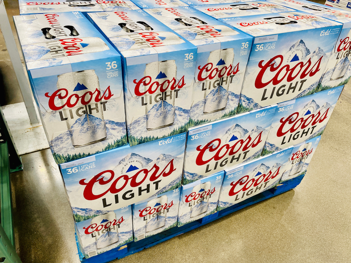 Large 36 packs of Coors Light beer cases on a pallet at Costco warehouse.