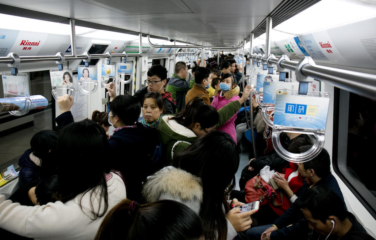 Subway riders in crowded subway car in Beijing, China