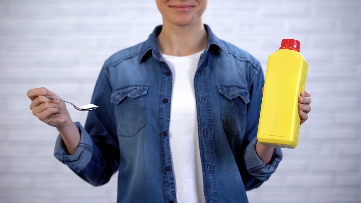 Woman holding a spoon of baking soda