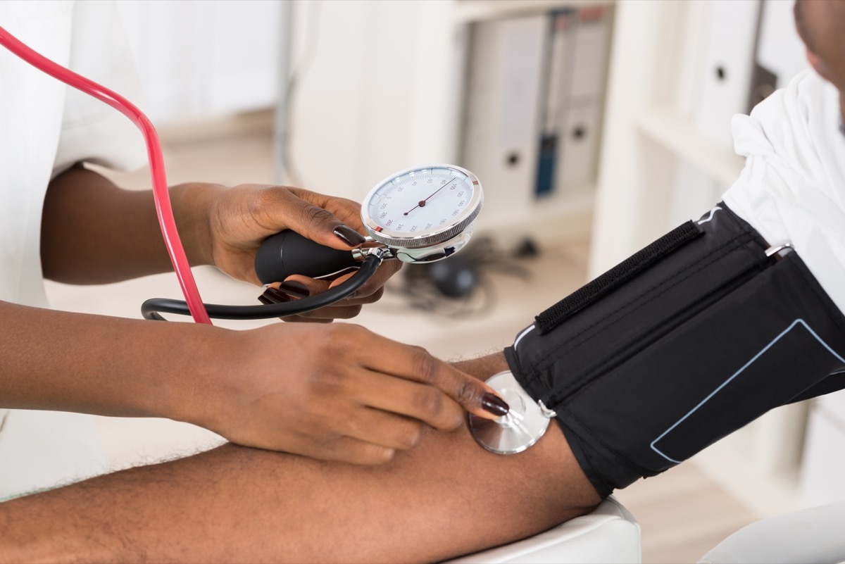 Doctor checking patient's blood pressure