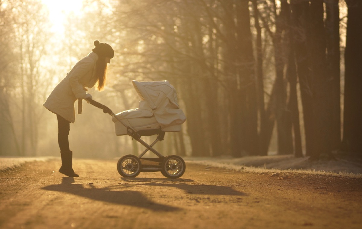 woman looking in stroller bassinet, ways parenting has changed.