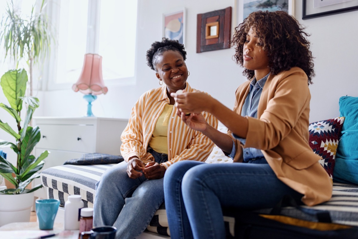 Female nutritionist advising patient on vitamin intake during consultation