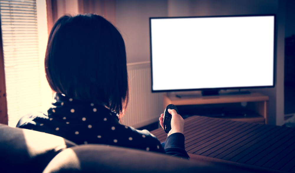 woman watching tv dorm room