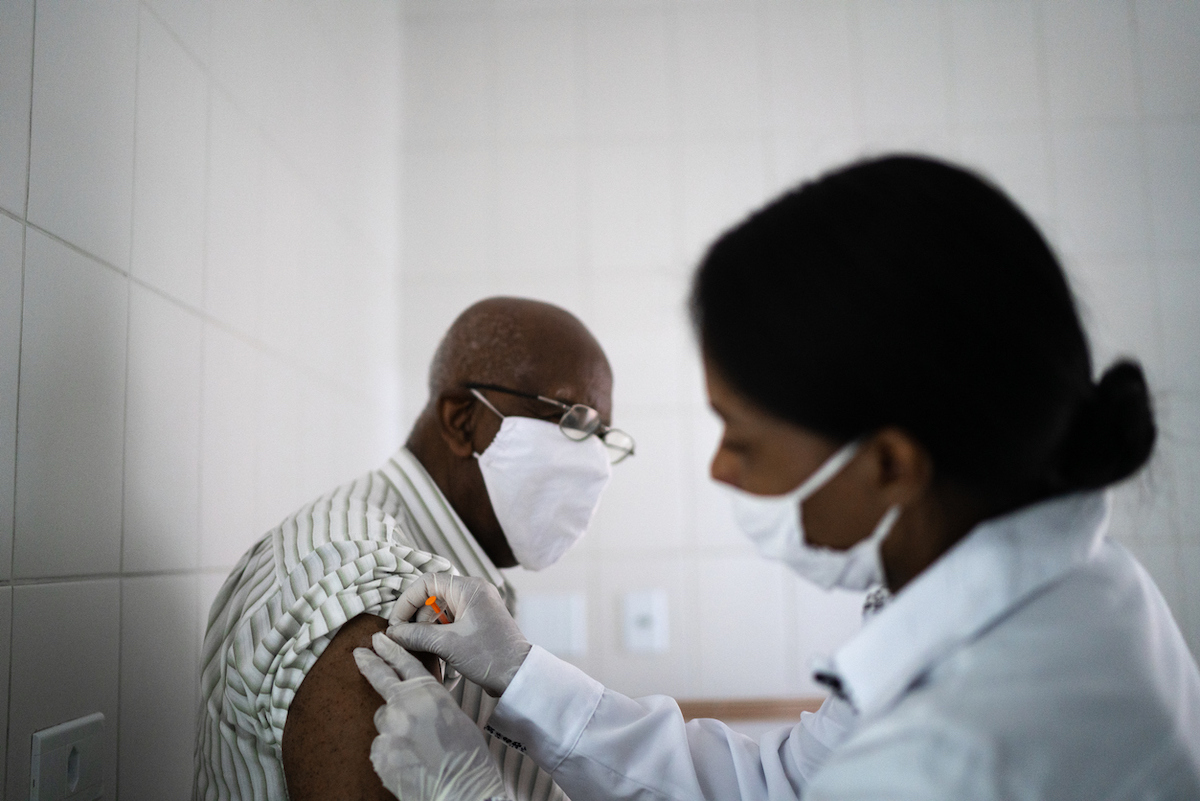 Doctor giving a vaccination shot to a senior patient