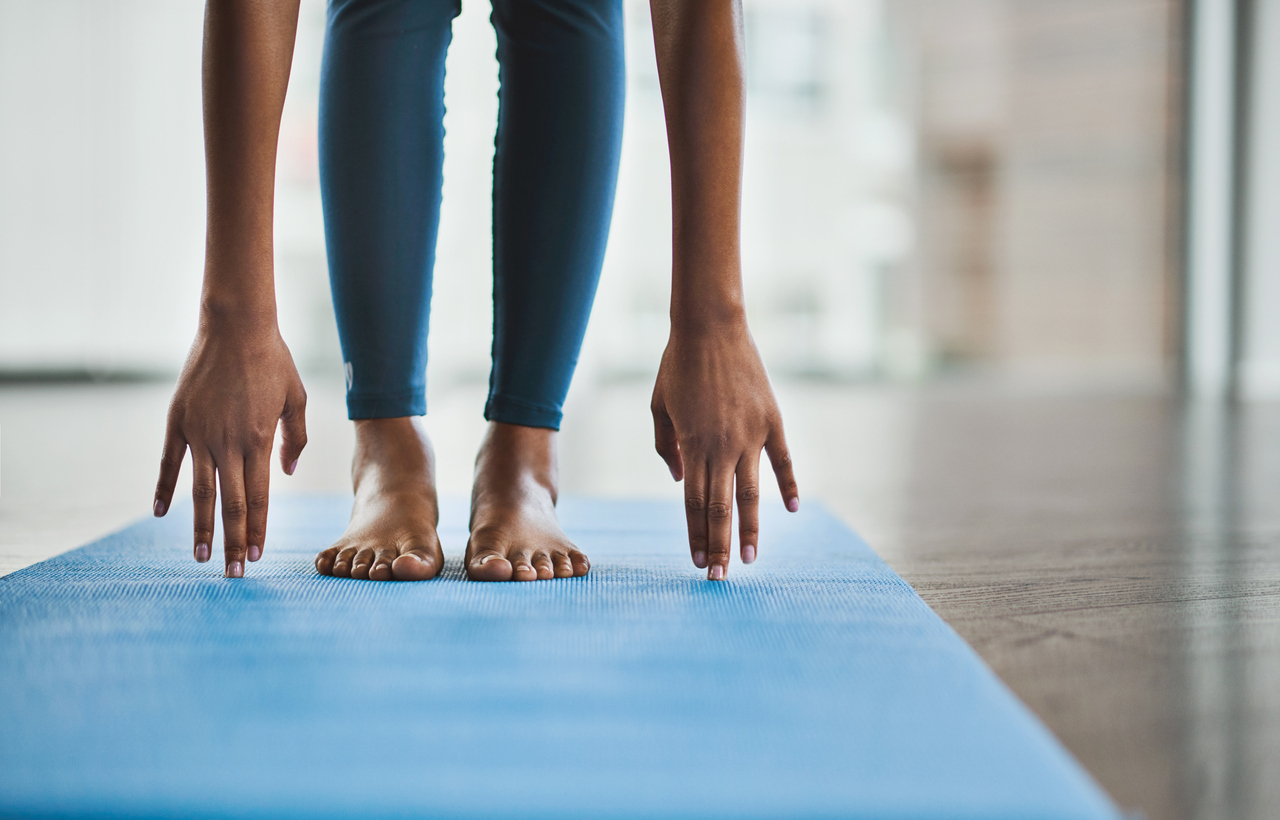 Woman practicing a yoga routine at home.