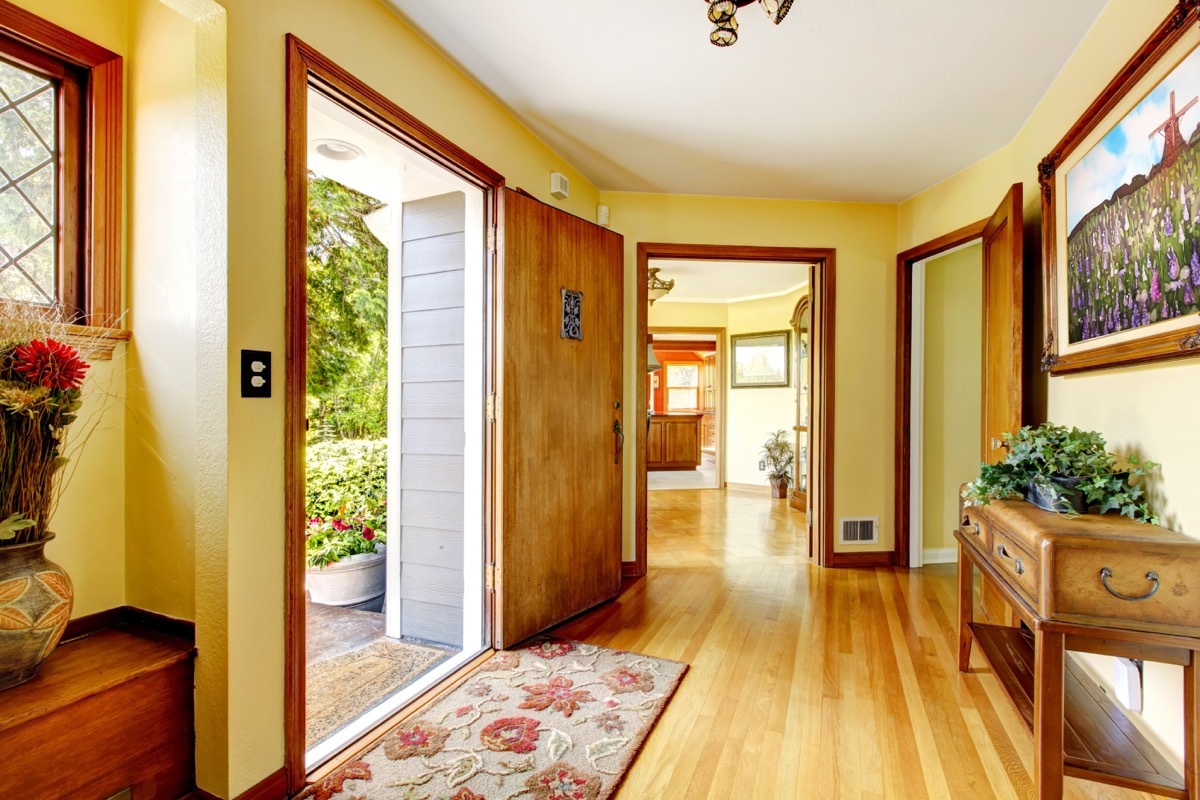 yellow hallway with furniture in it