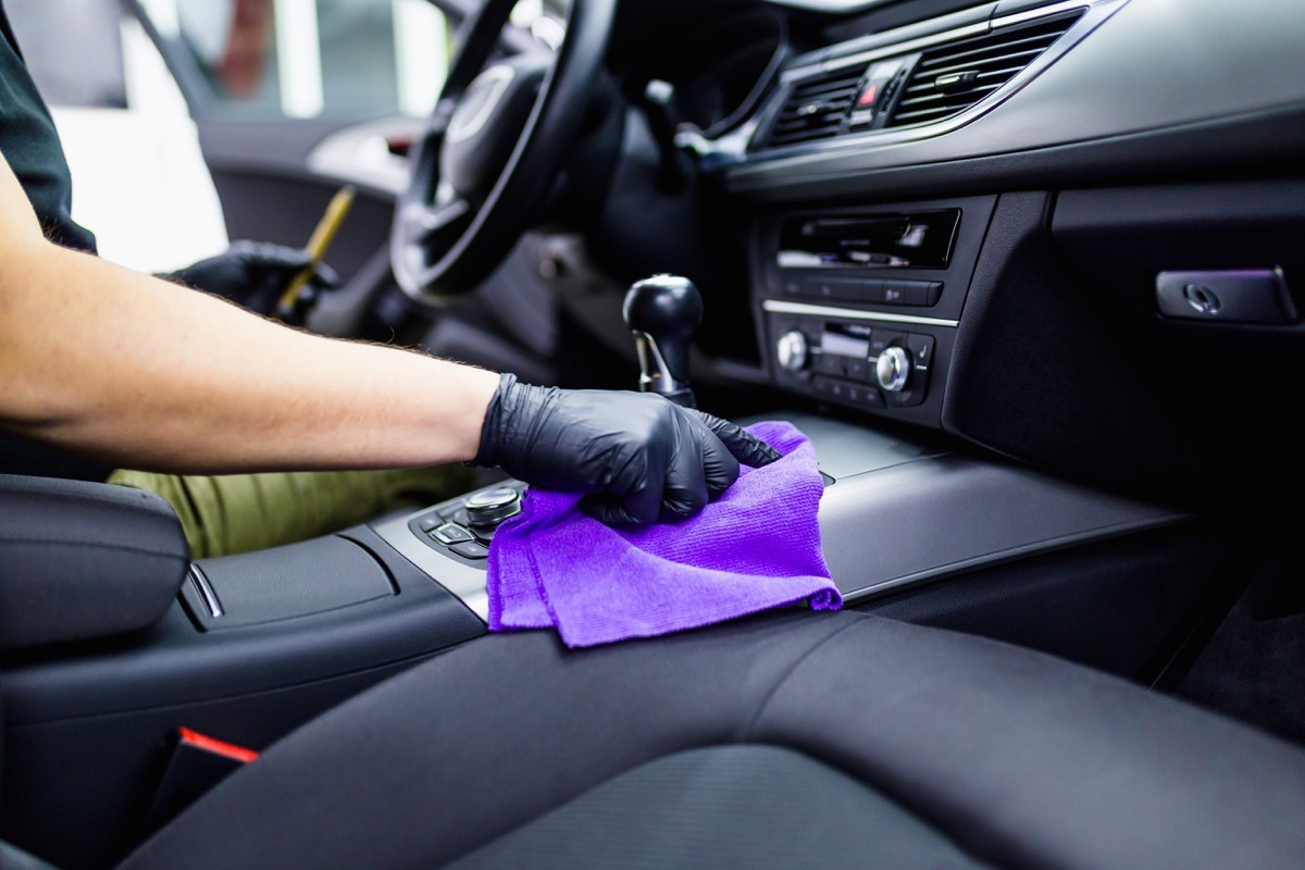 A man cleaning car interior, car detailing