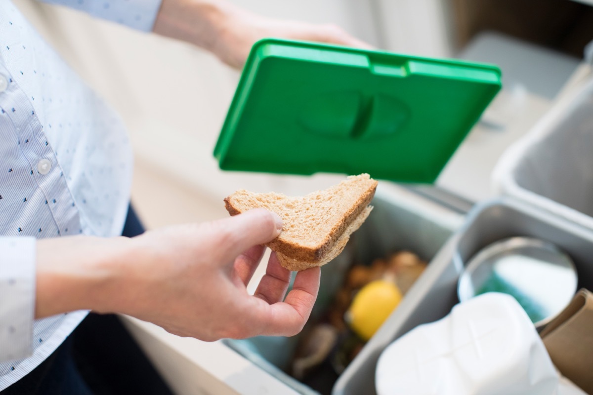 person throwing away sandwich