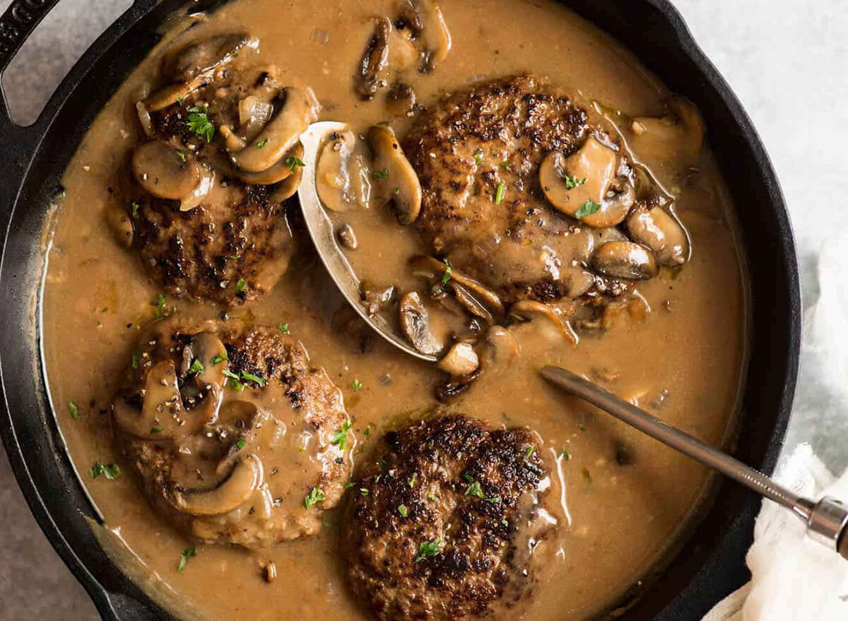 salisbury steak with mushroom gravy in cast iron pan