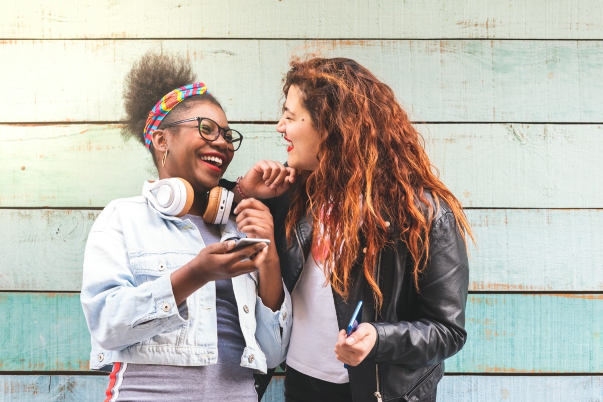 Two young women friends laughing