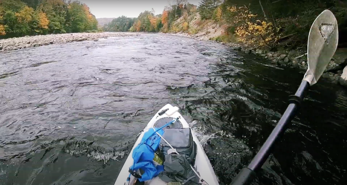 man kayaks down a river in lyman falls state park