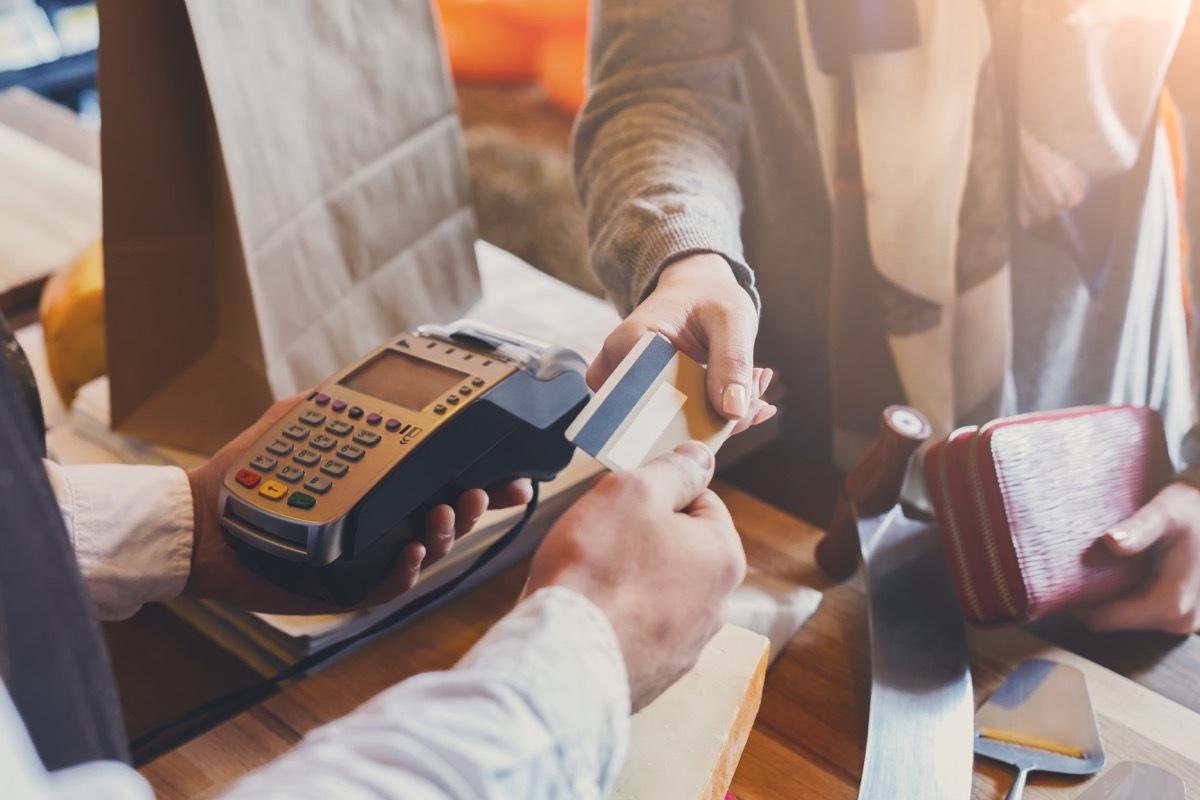 Woman making a purchase with card at store