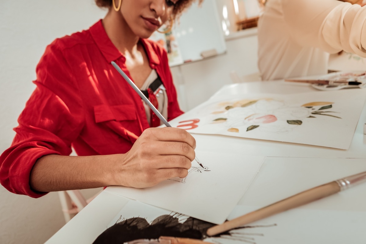 woman painting in art class