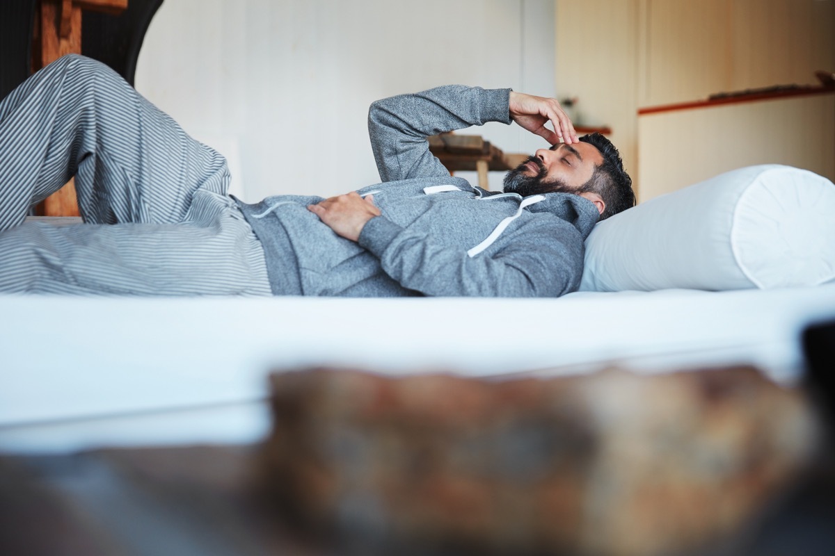 Fatigued man resting on couch