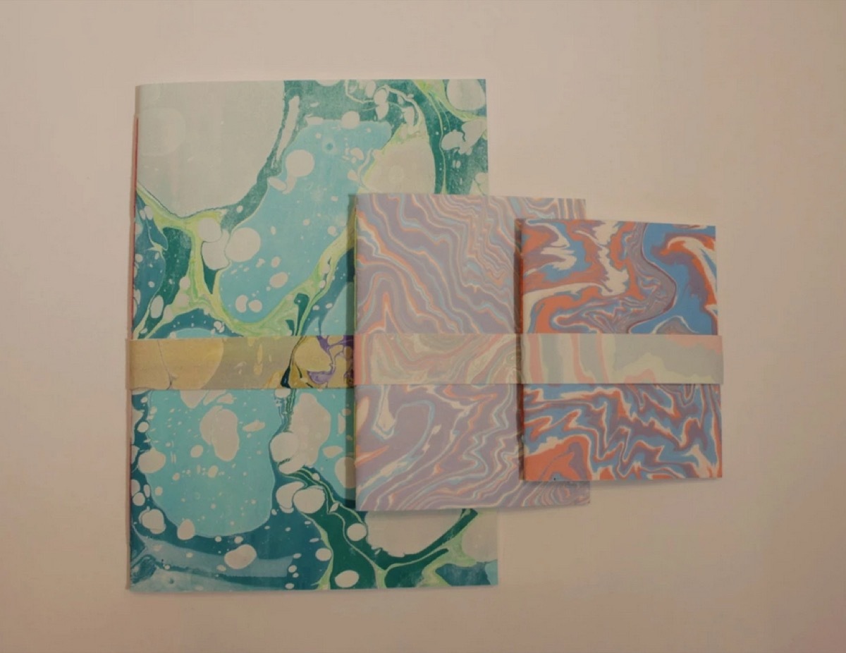 set of three notebooks with colorful marbled covers