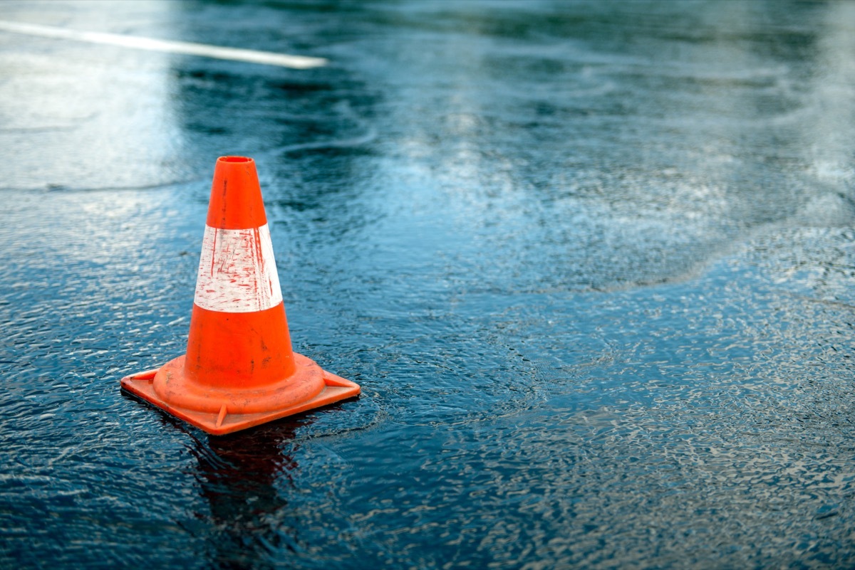 Traffic cone on rainy street