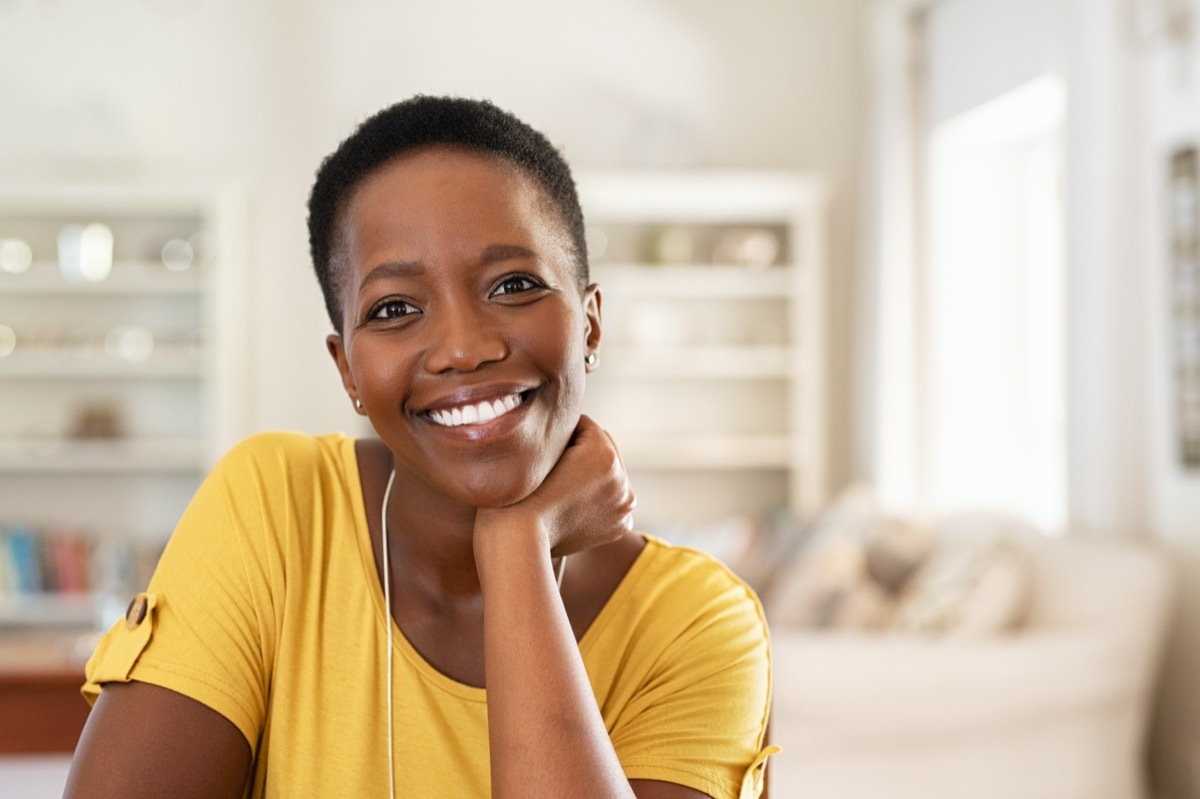 with short hair in casual sitting in her new apartment with copy space