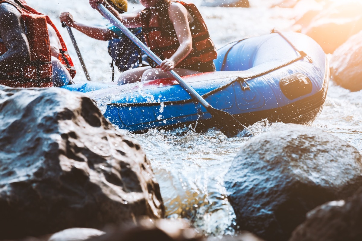 young person white water rafting