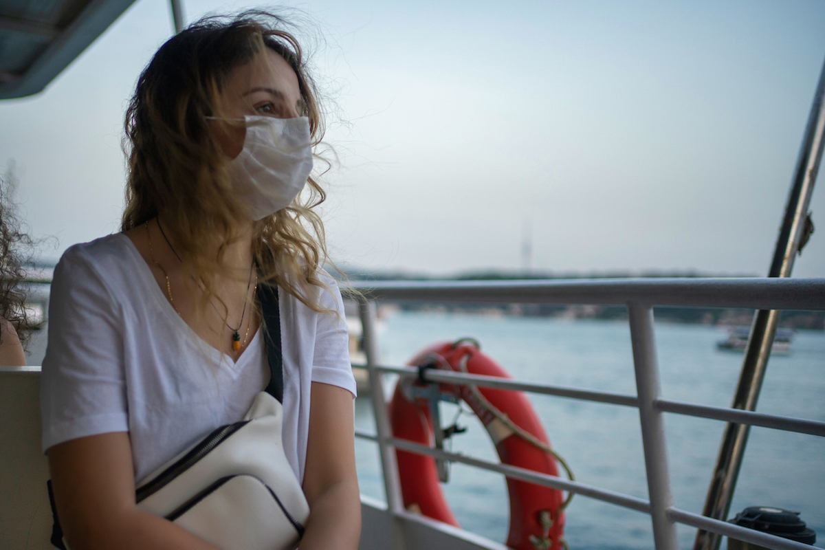 woman with protective face mask on the ferry