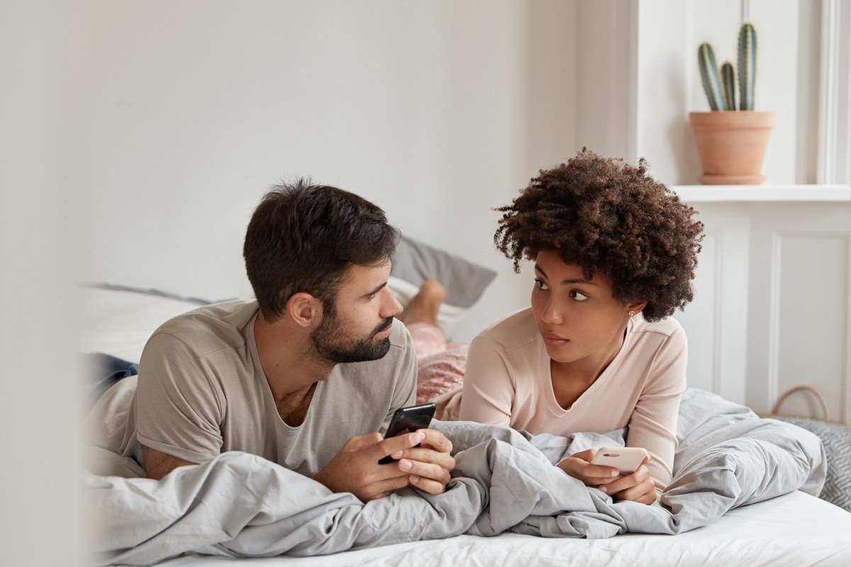 Couple having a serious talk in bed