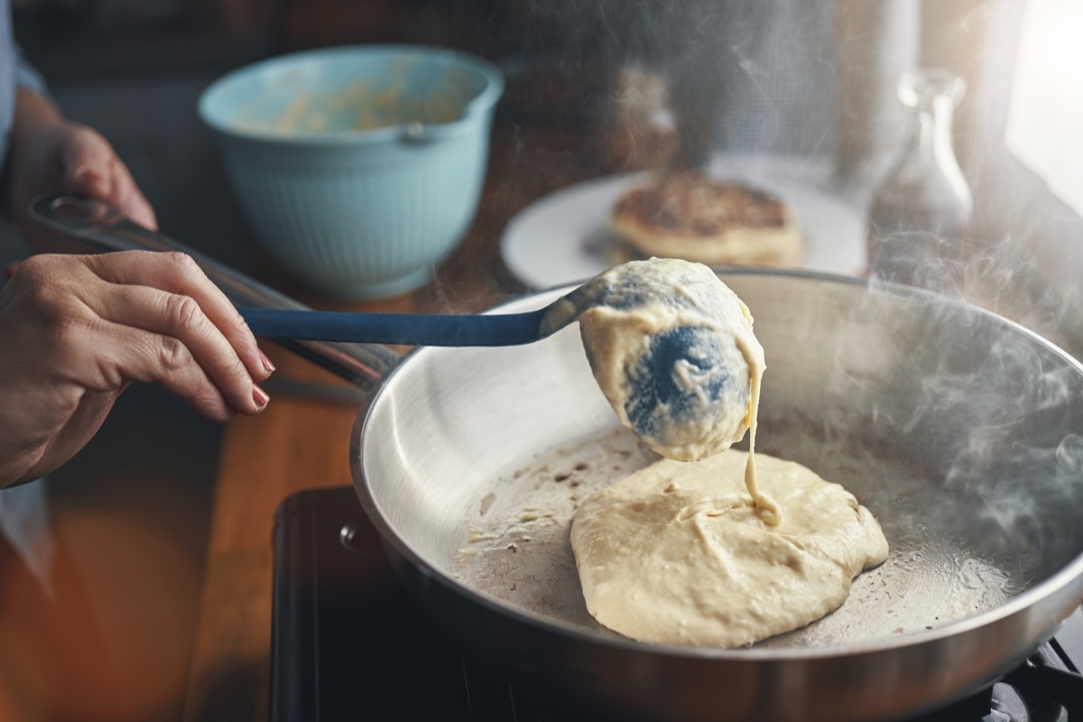 Preparing Pancakes with Blueberries in Domestic Kitchen